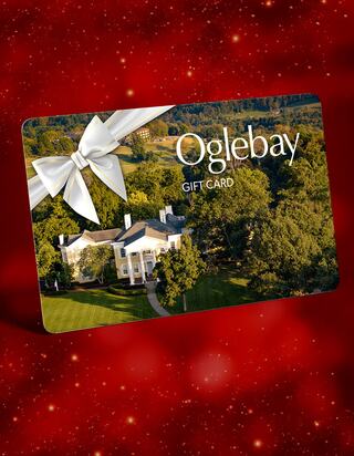 A gift card featuring a picturesque mansion and lush greenery, adorned with a decorative bow against a festive red background.