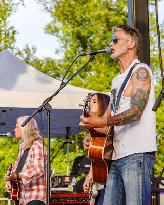 two young women laughing and dancing at sunset