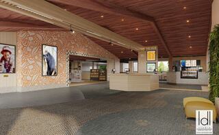 A spacious, modern lobby features wood accents, vibrant wall art, digital displays, and colorful seating, creating an inviting atmosphere.