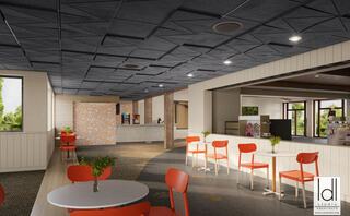 A modern cafe setting featuring orange chairs, round tables, and a textured ceiling, creating a bright and inviting atmosphere.