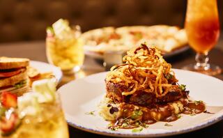 A delicious meatloaf topped with crispy onions, served on mashed potatoes.