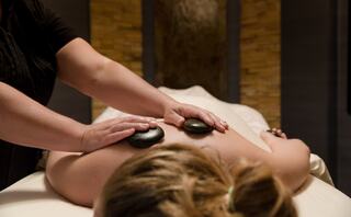 women getting a massage with hot stones