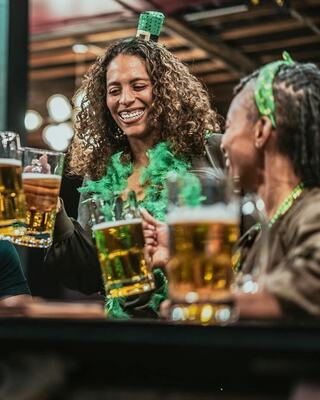 Two ladies enjoying pint of beer on St. Patrick's Day