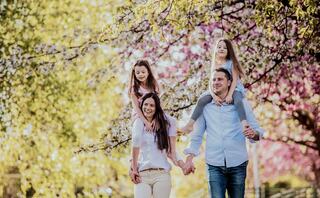 family of four walking outside in the spring