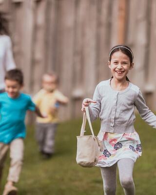 a girl running with a basket in her hands