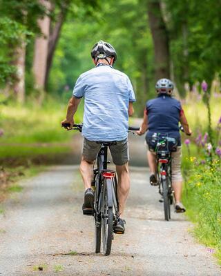 Person riding a bicycle on a paved trail